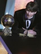 Messi of Argentina FIFA World Player 2010 stands nexthis trophy during the FIFA Ballon d'Or 2010 soccer awards ceremony in Zurich
