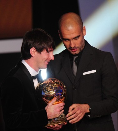 Argentina's Lionel Messi (L) is awarded